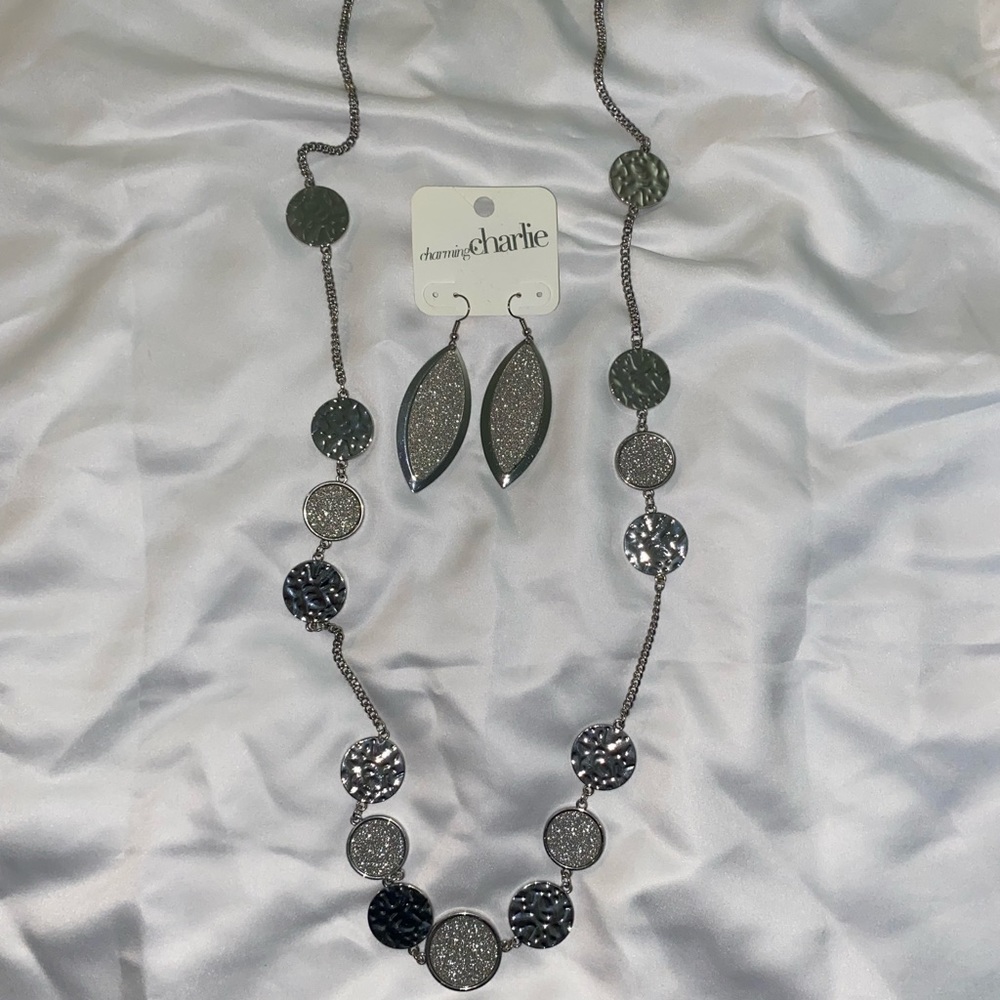 Charming Charlie’s brand new long silver necklace with matching earring.